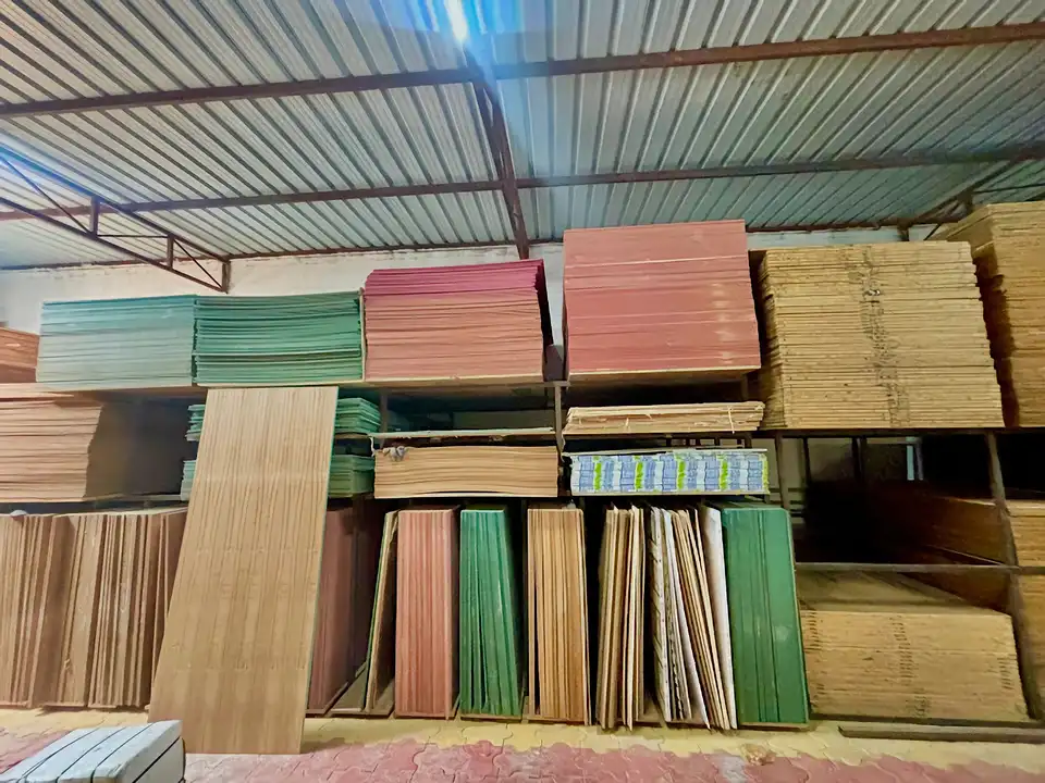 Warehouse racks holding coloured MR boards and natural plywood sheets