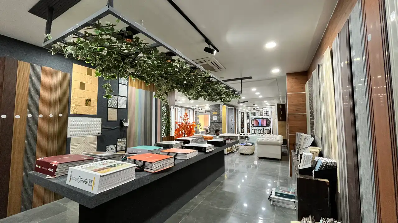Showroom display hall with wall-panel samples, catalogue counter and lounge seating