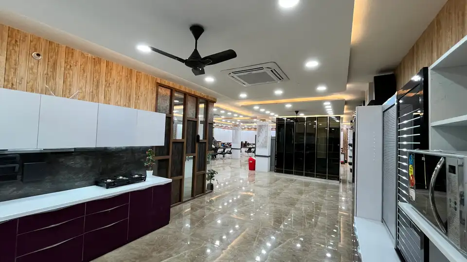 Showroom interior with modular kitchen display, wardrobe units and polished floor