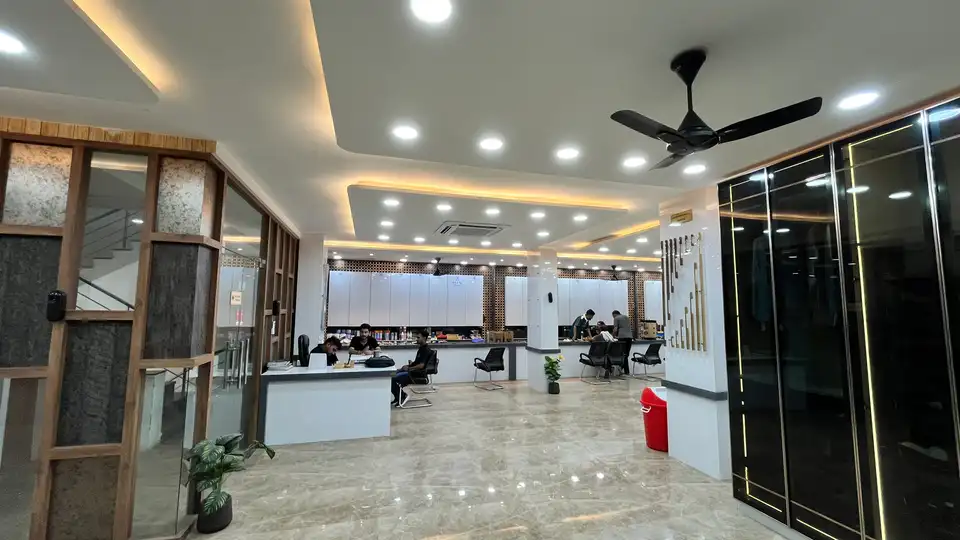 Bright showroom floor with reception counter, black glass display and staff desks